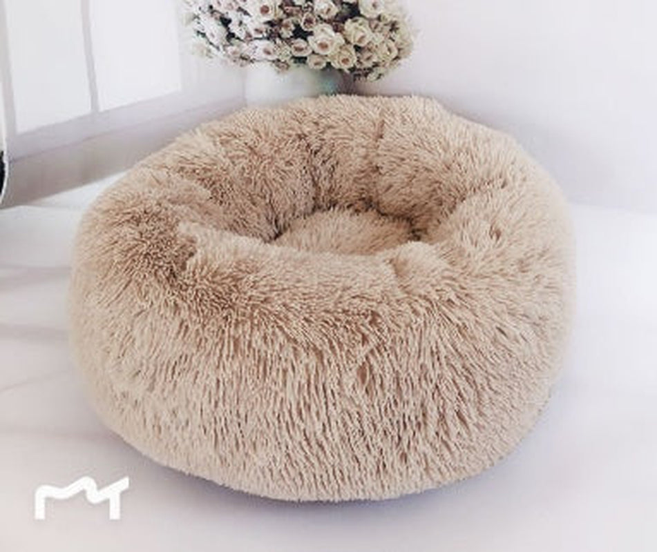All Dogs Love plush round calming pet bed in beige with a raised rim for head support and cozy long-pile fabric.