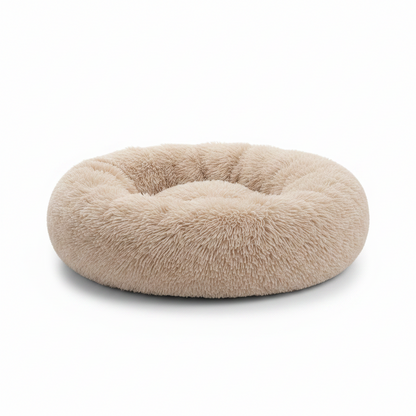 All Dogs Love plush round calming pet bed in beige with a raised rim for head support and cozy long-pile fabric.
