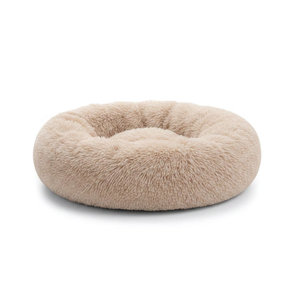 All Dogs Love plush round calming pet bed in beige with a raised rim for head support and cozy long-pile fabric.