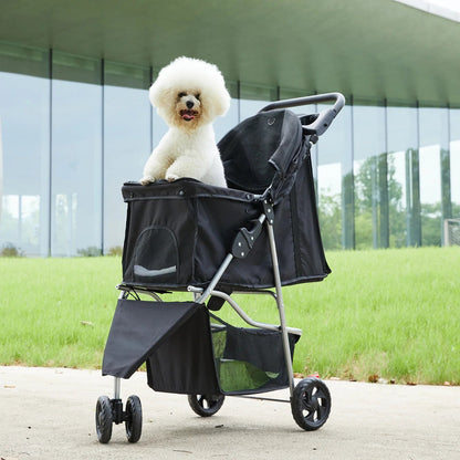 All Dogs Love foldable 3-wheel black pet stroller with a white poodle sitting inside on a paved park path