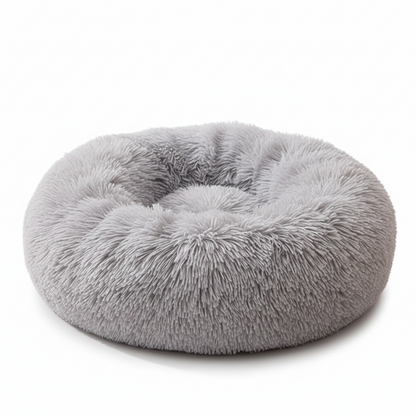 All Dogs Love plush round calming pet bed in light grey with a raised rim for head support and cozy long-pile fabric